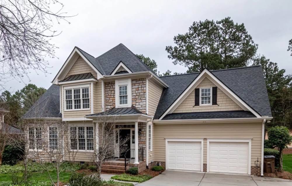 A residence with a driveway and trees in Taylor