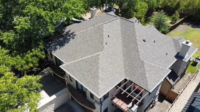 A bird's eye view of a house with residential roofing in Taylor