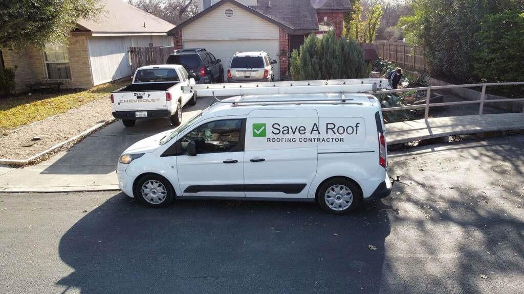 A white van equipped with a ladder for Save A Roof TX