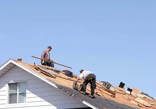 Workers Repairing A Roof In Austin, TX