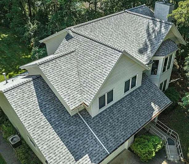 A home with a driveway and trees in Pflugerville