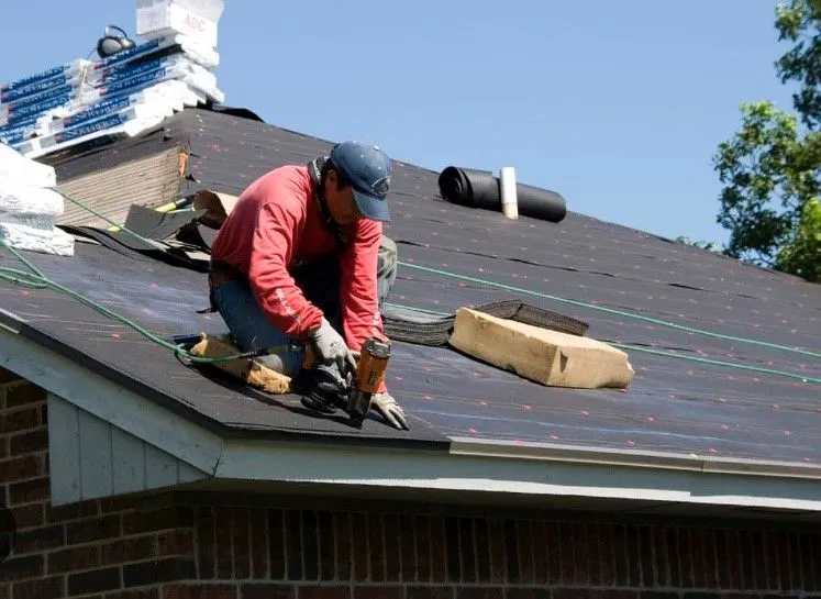 A person repairing a roof in Georgetown