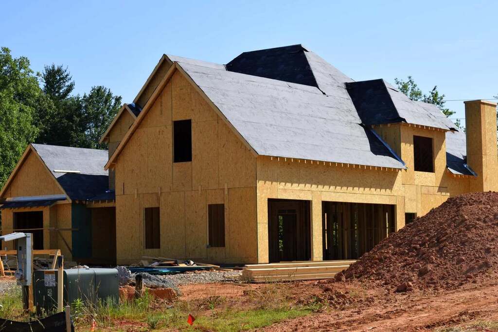 A house under construction in the sun with Save A Roof TX