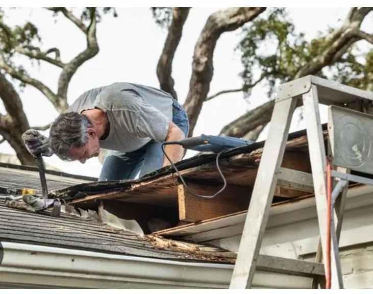 A person on a roof for emergency repair in Austin