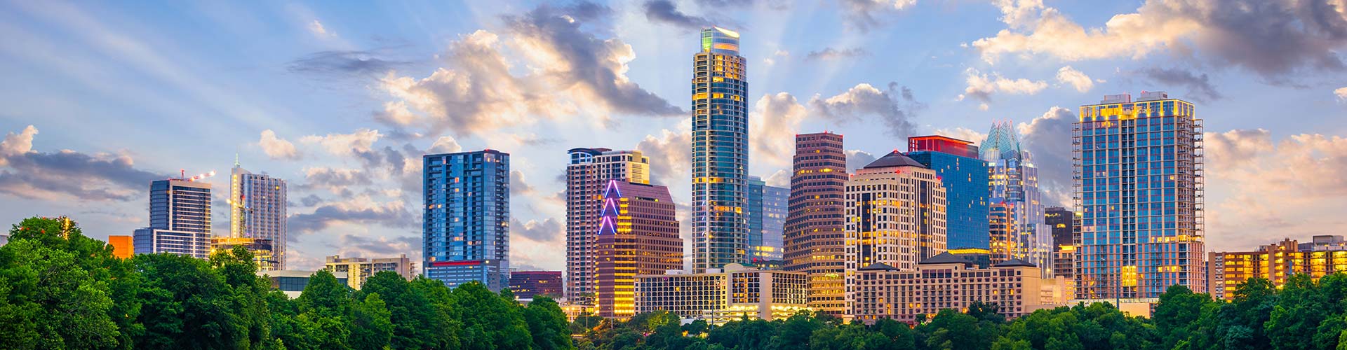 A cityscape featuring trees and clouds in Round Rock