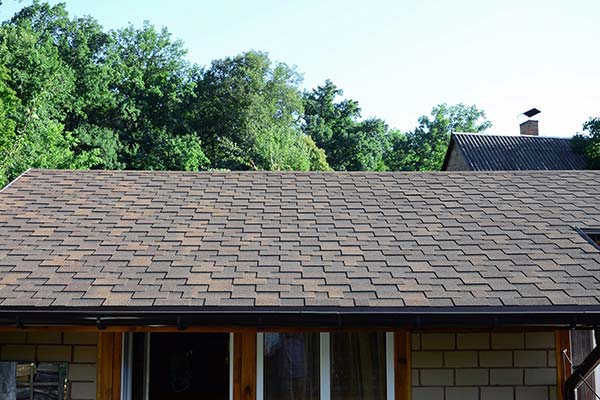 A roof of a house with trees in the background in Kyle