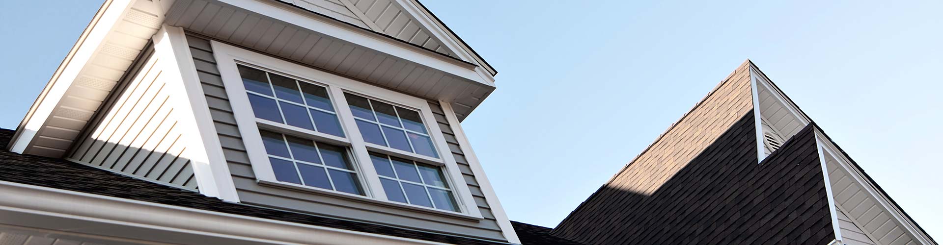 A close-up of the second story of a house with roofing repair