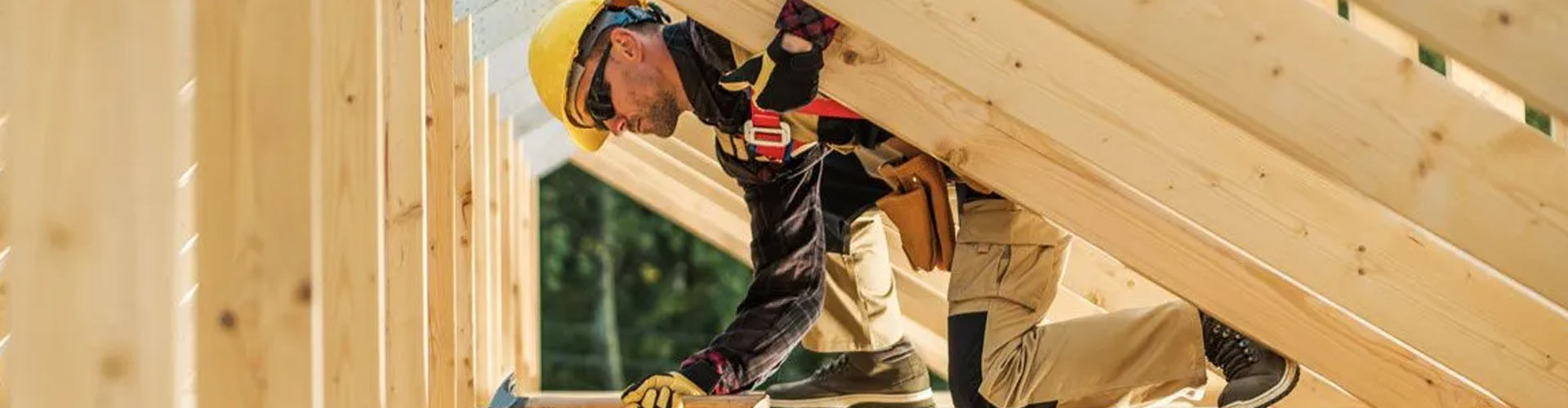 A person working between roofing beams in Leander